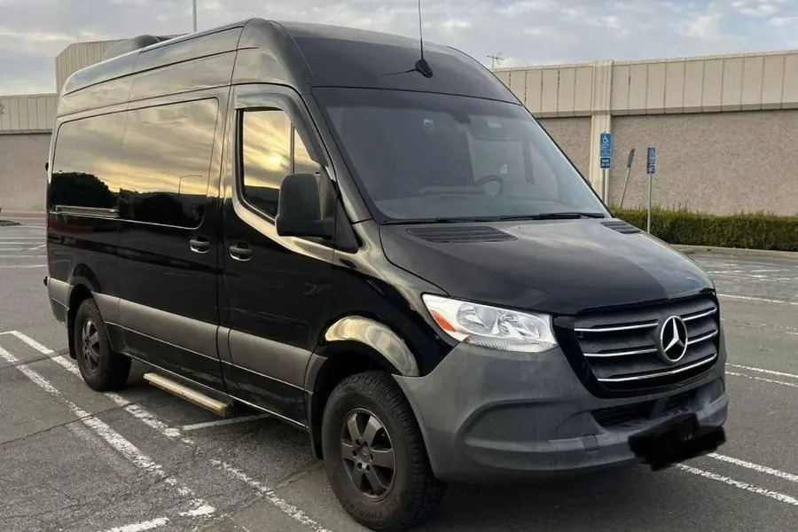 Black Mercedes-Benz Sprinter 14-passenger van owned by Umbrella Global Bus