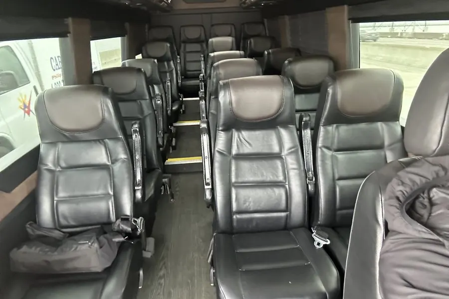 Mercedes Sprinter interior with black leather captain's chairs